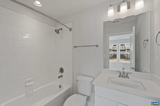 a bathroom with a sink toilet tub and shower