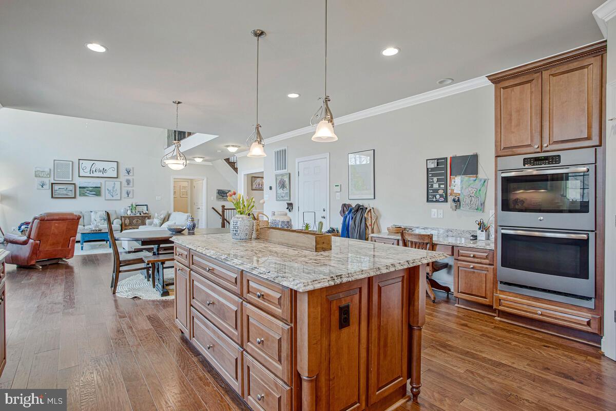 54 Simmons Ridge Road Prince Frederick, MD 20678 - Photo 21 of 55 a open kitchen with stainless steel appliances granite countertop a stove and chairs with wooden floor