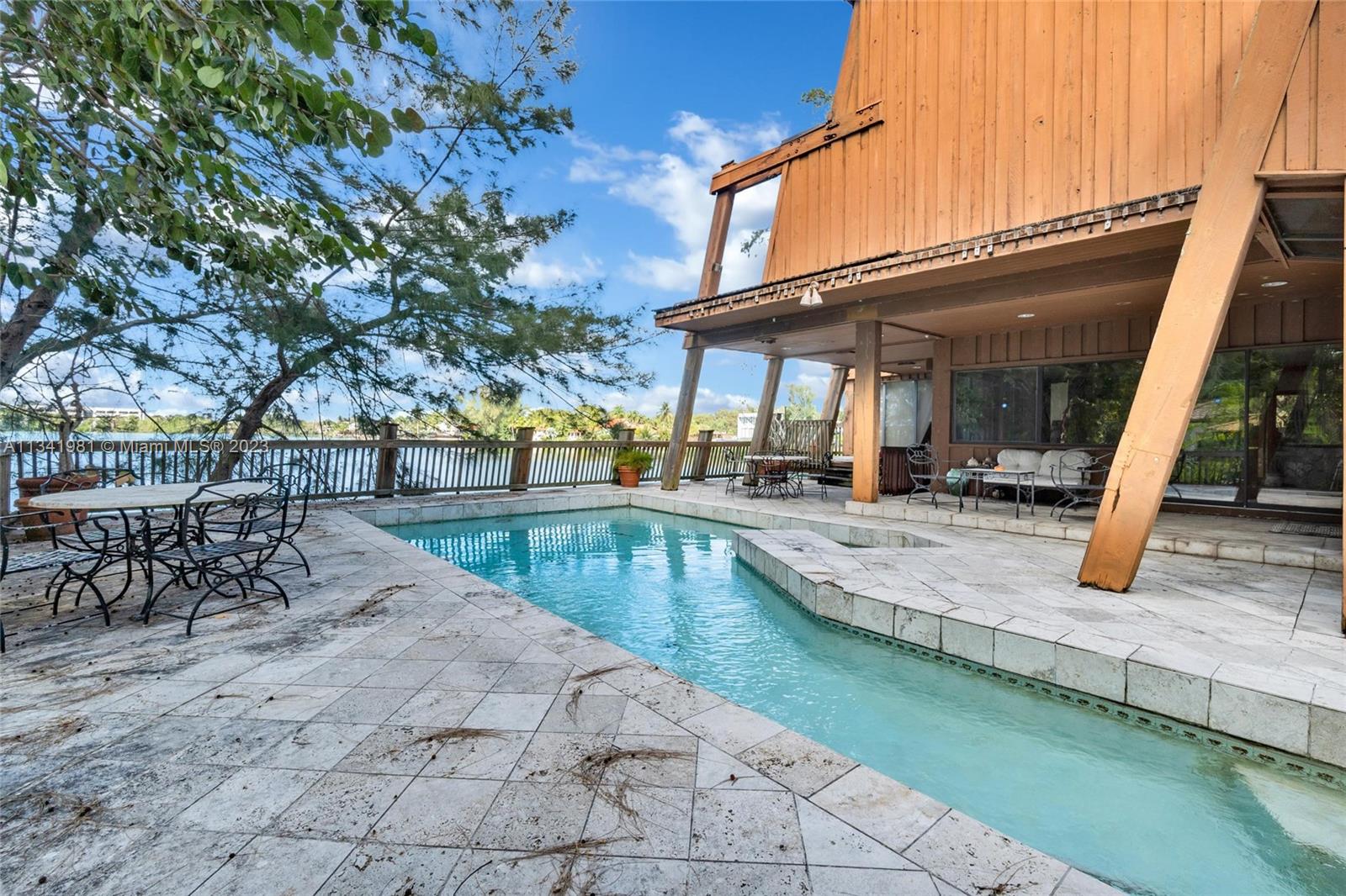 7261 Miller Drive Miami, FL 33155 - Photo 3 of 11 a view of a swimming pool with a patio