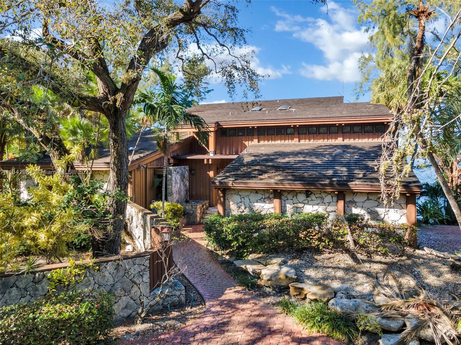 7261 Miller Drive Miami, FL 33155 - Photo 7 of 11 a view of house with a tree