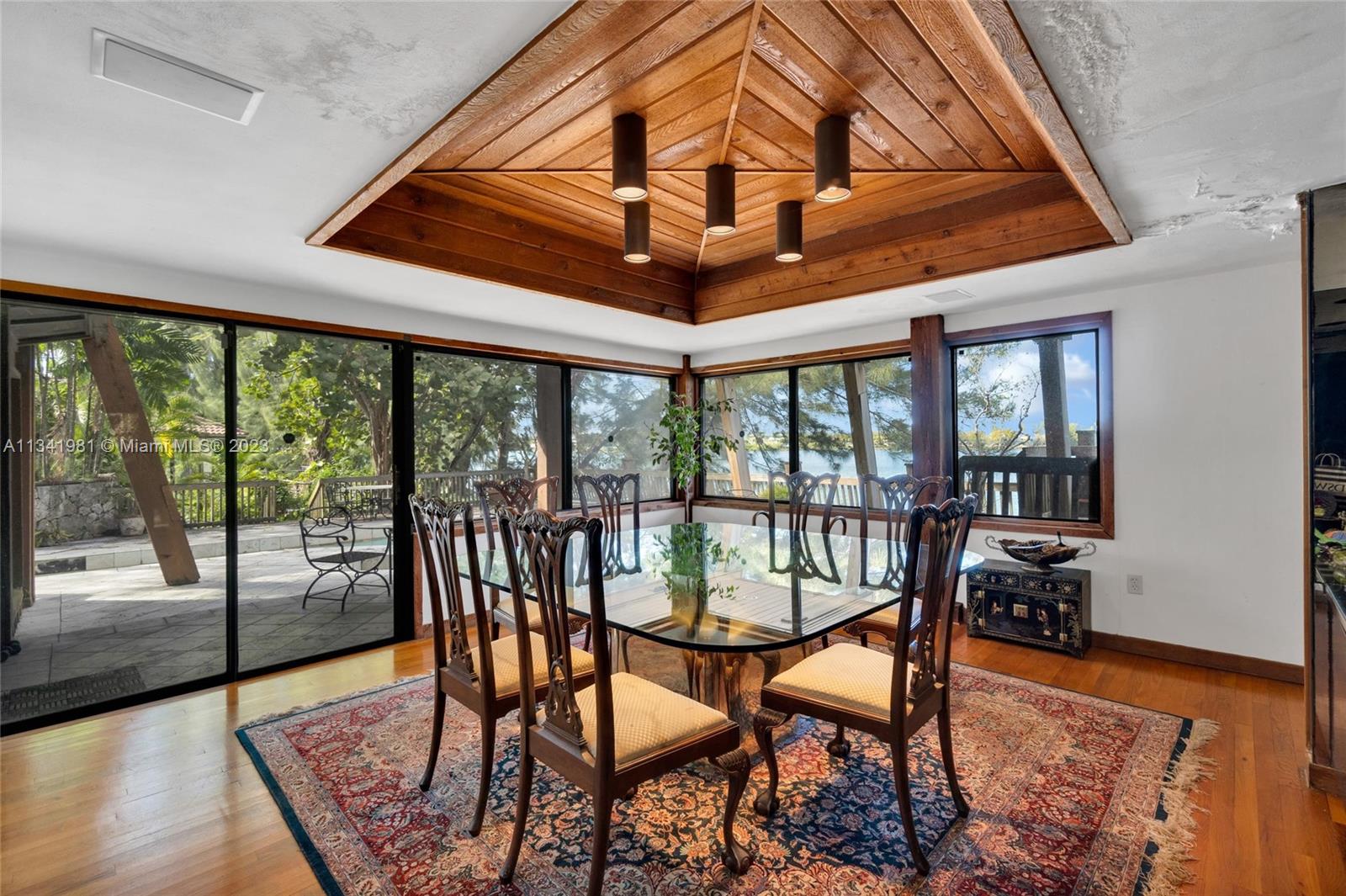 7261 Miller Drive Miami, FL 33155 - Photo 8 of 11 a dining room with furniture wooden floor and a rug