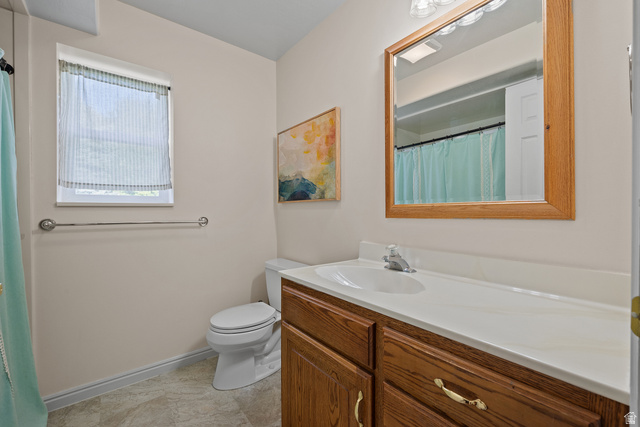 555 East 1700 N Street Mapleton, UT 84664 - Photo 45 of 49 Bathroom featuring a single vanity with wood-finish cabinetry, a white countertop, and an integrated sink
