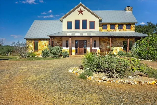 a front view of a building with a garden