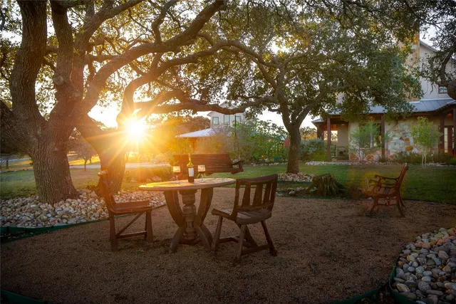a view of a chairs and table in backyard