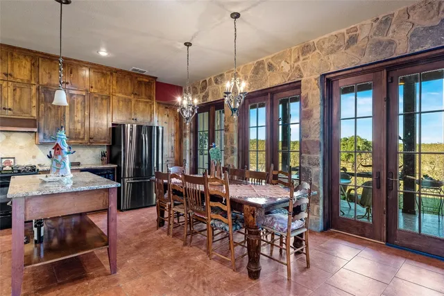 a view of a dining room with furniture water view and a chandelier