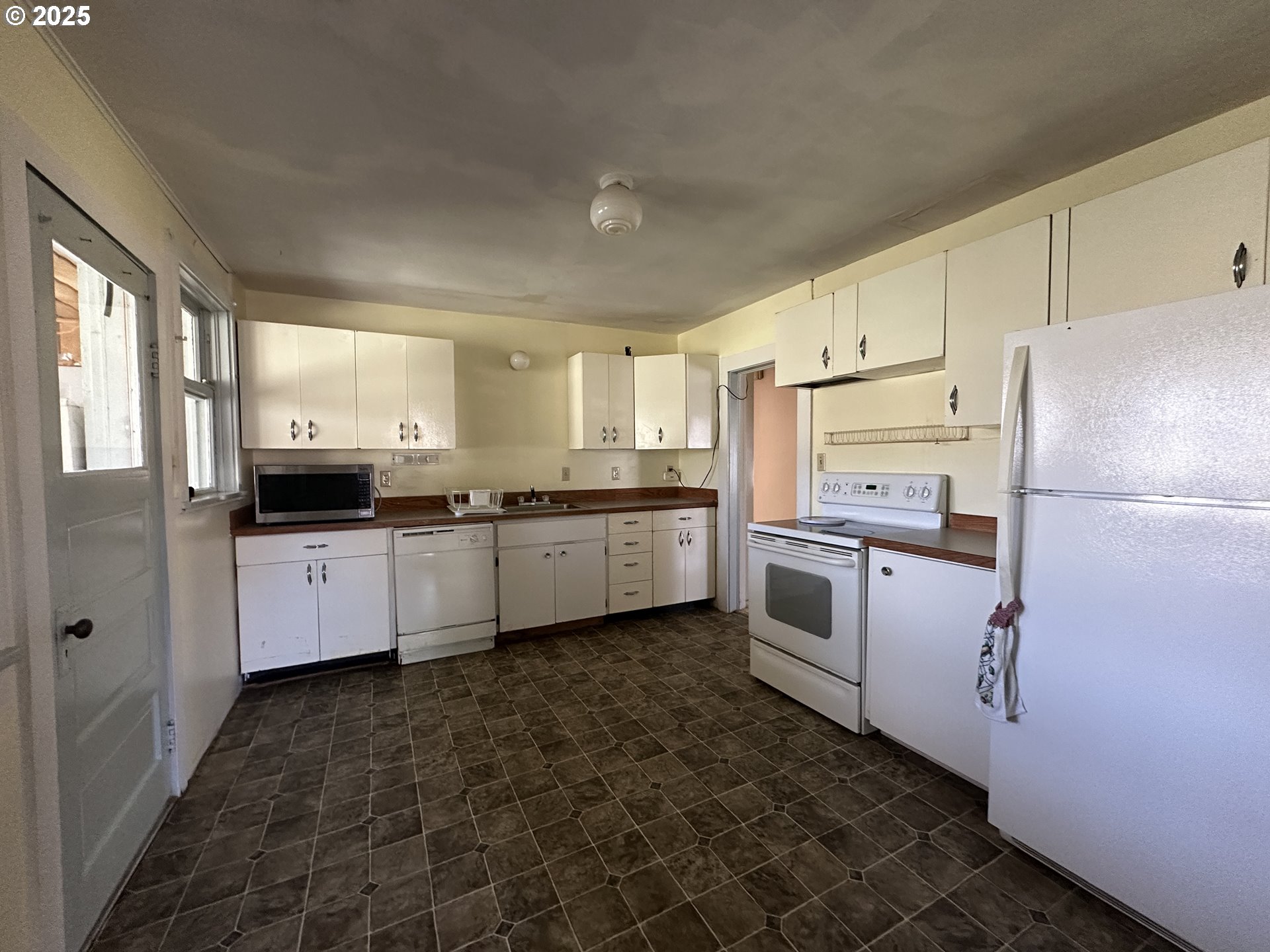 101 First Street Fossil, OR 97830 - Photo 13 of 13 a kitchen with a white cabinets and white stainless steel appliances