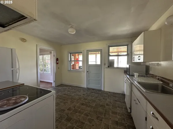 a kitchen that has a sink and a stove