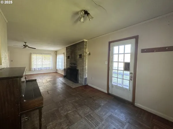 wooden floor in an empty room with a window