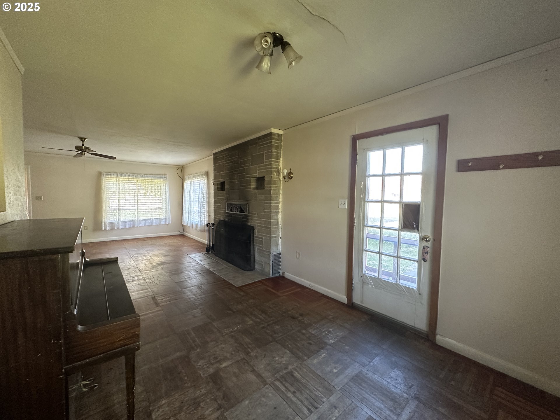 101 First Street Fossil, OR 97830 - Photo 9 of 13 wooden floor in an empty room with a window