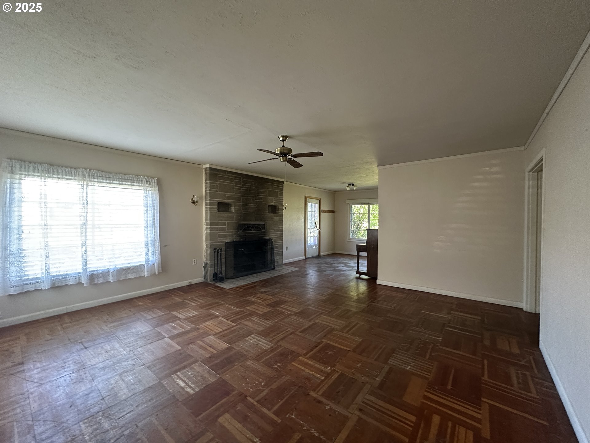101 First Street Fossil, OR 97830 - Photo 10 of 13 an empty room with windows and fireplace
