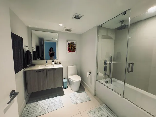 a bathroom with a toilet sink and mirror