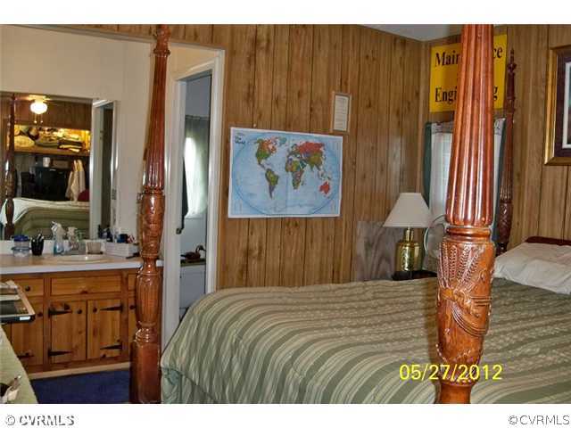 291 Mountain Hall Road Crewe, VA 23930 - Photo 6 of 12 a bedroom with a bed and a painting on the wall