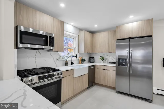 a kitchen with a sink stainless steel appliances and cabinets