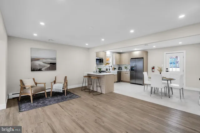 a open kitchen with white cabinets and stainless steel appliances