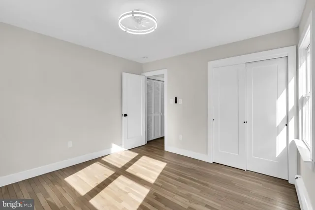 a view of room with window and wooden floor