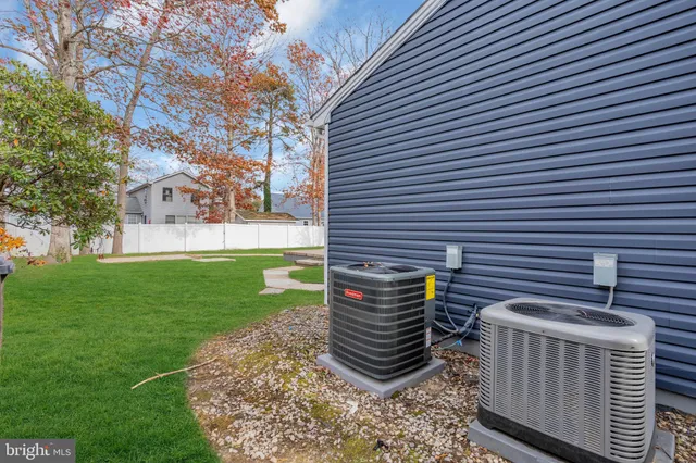 a backyard of a house with a garden and barbeque oven