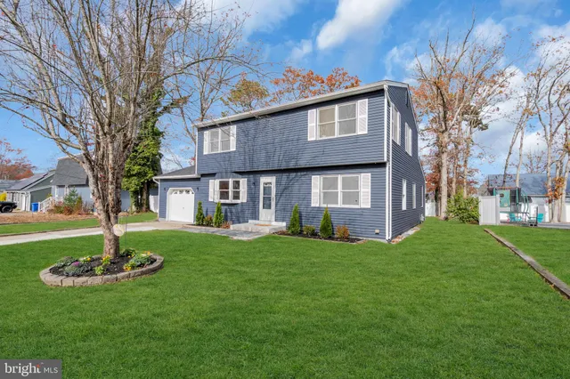 a view of a brick house with a yard