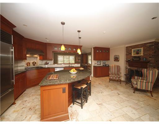 69 St Nicholas Road Darien, CT 06820 - Photo 9 of 20 a kitchen with stainless steel appliances granite countertop a sink and a refrigerator