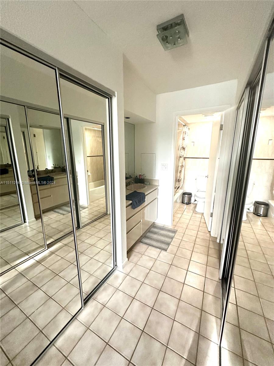 3730 Inverrary Drive, Unit 2P Lauderhill, FL 33319 - Photo 11 of 41 a bathroom with a glass door shower and view of a bathroom