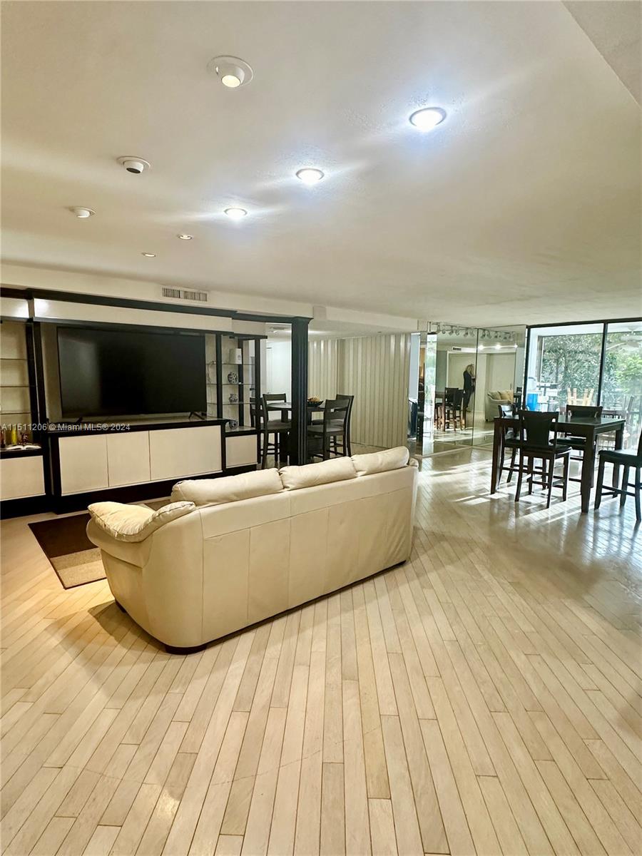 3730 Inverrary Drive, Unit 2P Lauderhill, FL 33319 - Photo 23 of 41 a living room with furniture and a flat screen tv