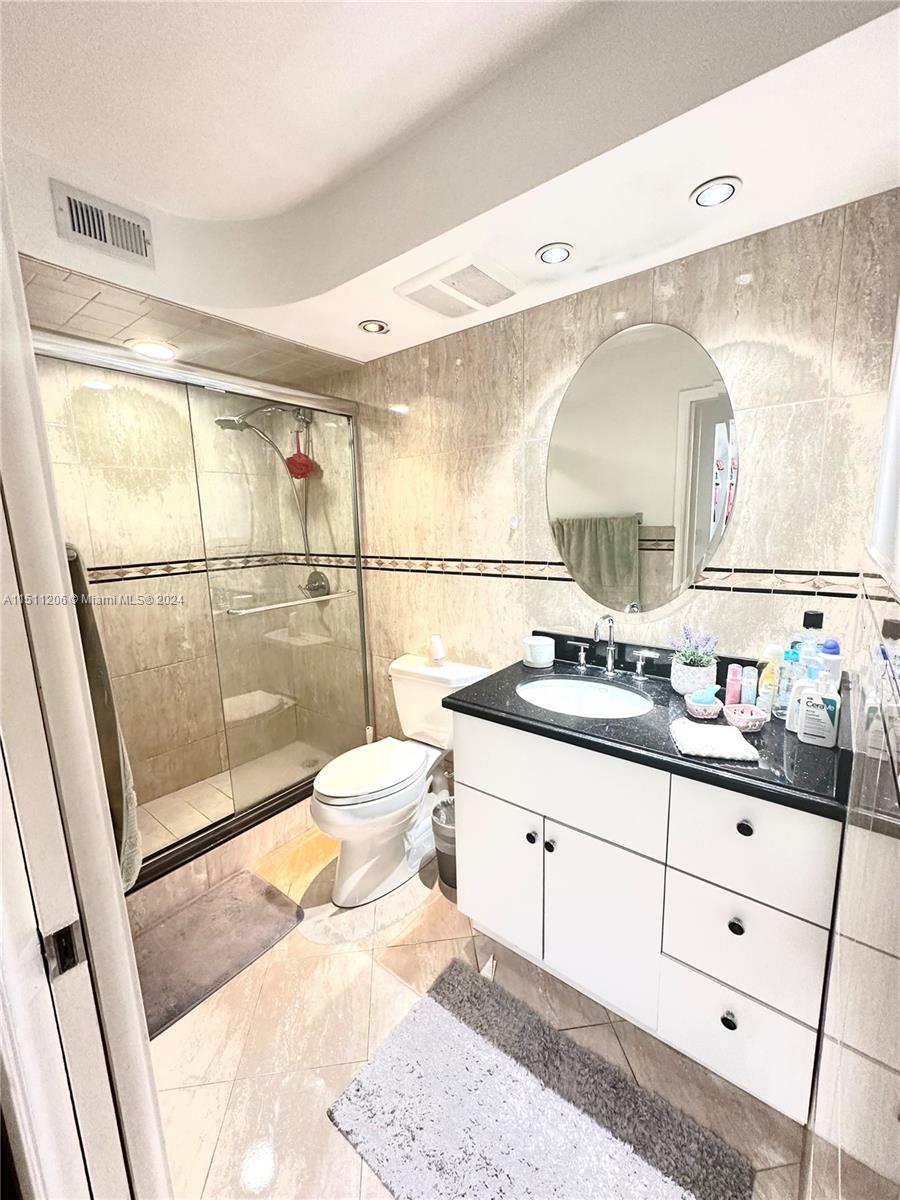 3730 Inverrary Drive, Unit 2P Lauderhill, FL 33319 - Photo 24 of 41 a bathroom with a sink mirror and a shower