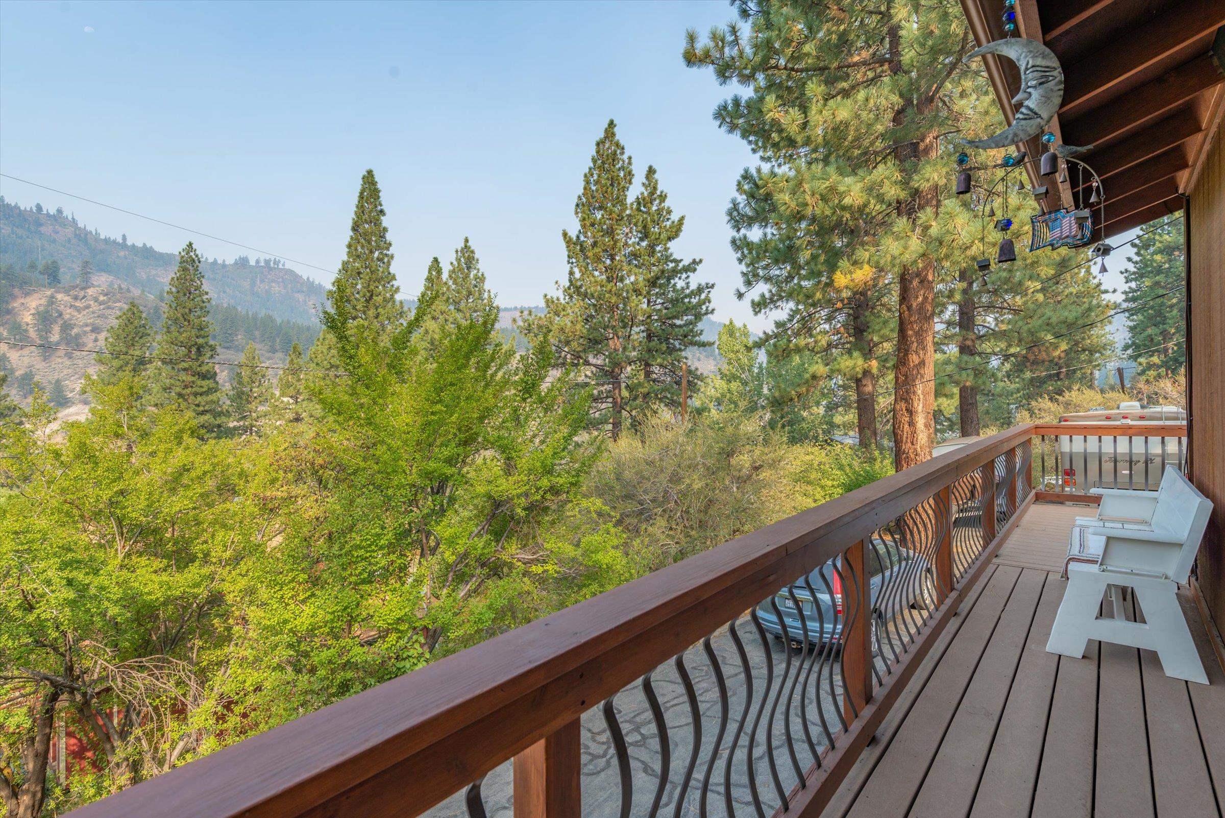 10341 Pine Way Floriston, CA 96111 - Photo 13 of 21 a view of a balcony with wooden floor and fence