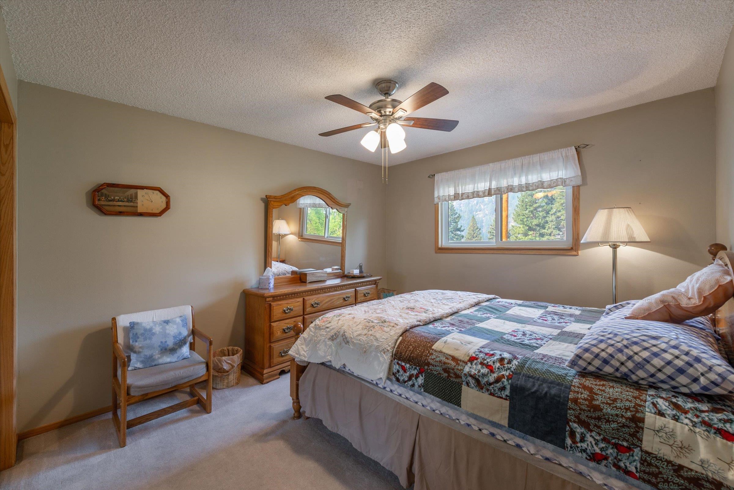 10341 Pine Way Floriston, CA 96111 - Photo 15 of 21 a bedroom with a bed and a chandelier