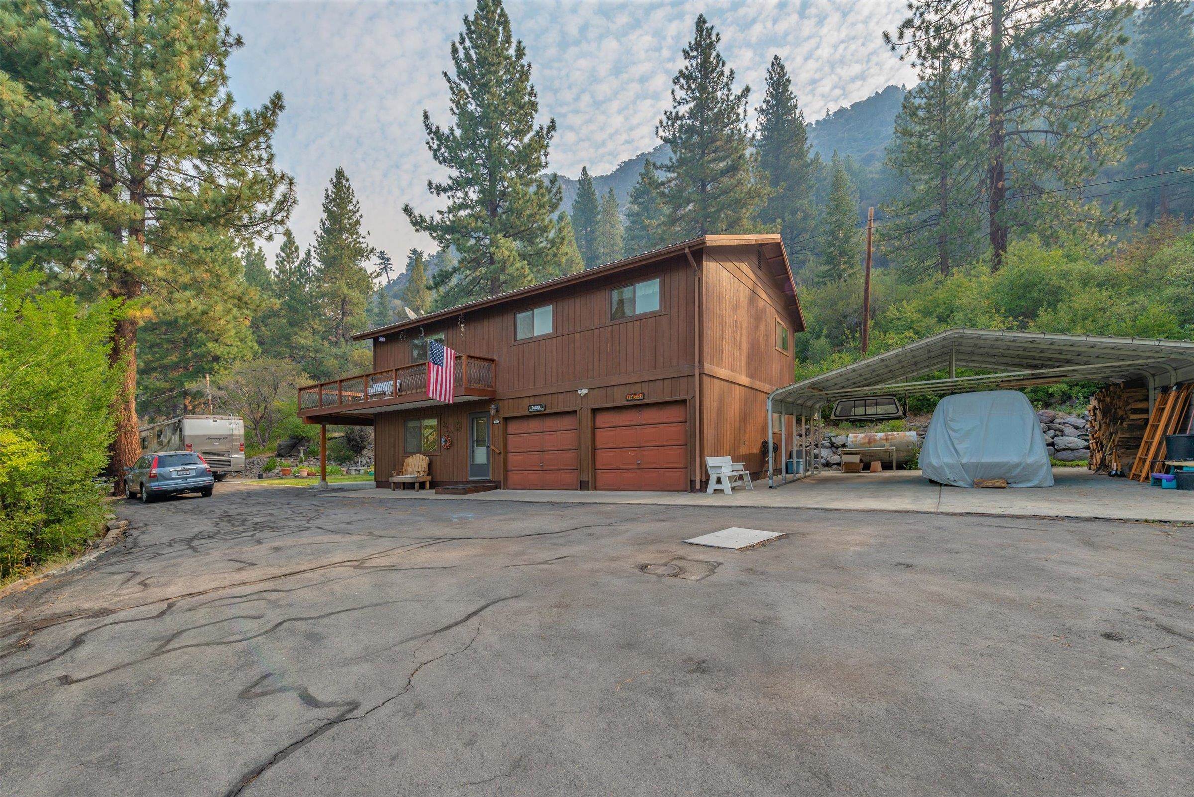 10341 Pine Way Floriston, CA 96111 - Photo 2 of 21 a view of a house with a yard and garage