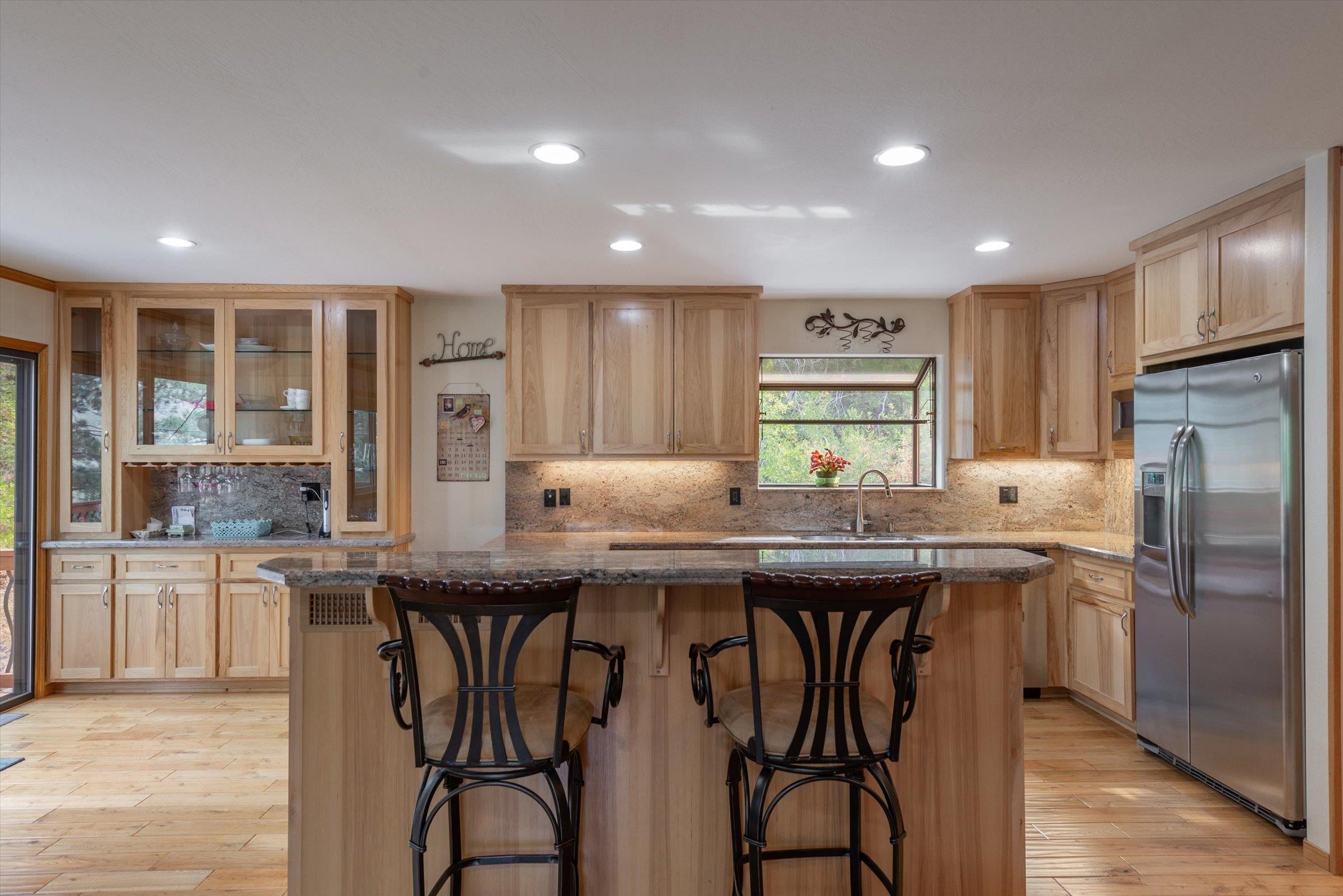 10341 Pine Way Floriston, CA 96111 - Photo 8 of 21 a kitchen with stainless steel appliances granite countertop a kitchen island a stove and a refrigerator