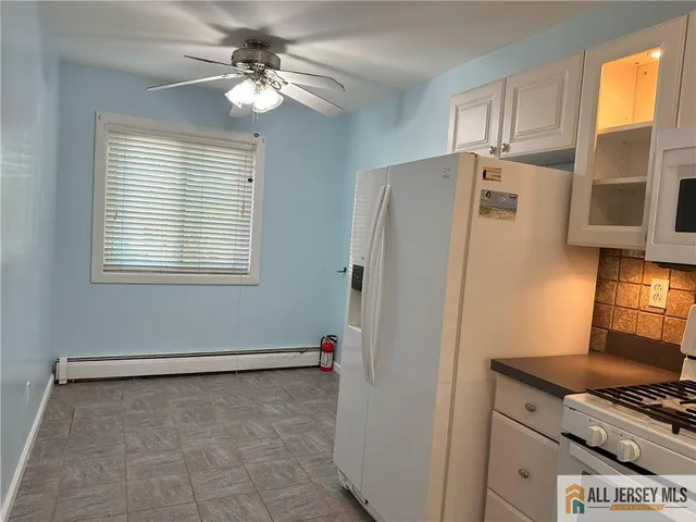 a kitchen with stainless steel appliances a refrigerator and a stove top oven
