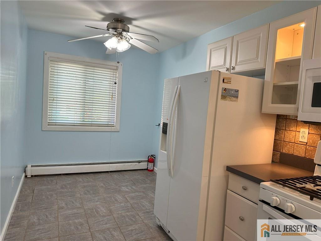 2 Lake Avenue, Unit 7B East Brunswick, NJ 08816 - Photo 3 of 10 a kitchen with stainless steel appliances a refrigerator and a stove top oven