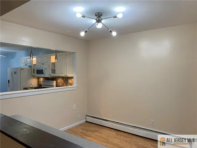 an empty room with a kitchen