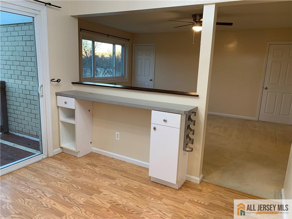 2 Lake Avenue, Unit 7B East Brunswick, NJ 08816 - Photo 6 of 10 a view of an empty room with wooden floor and a window