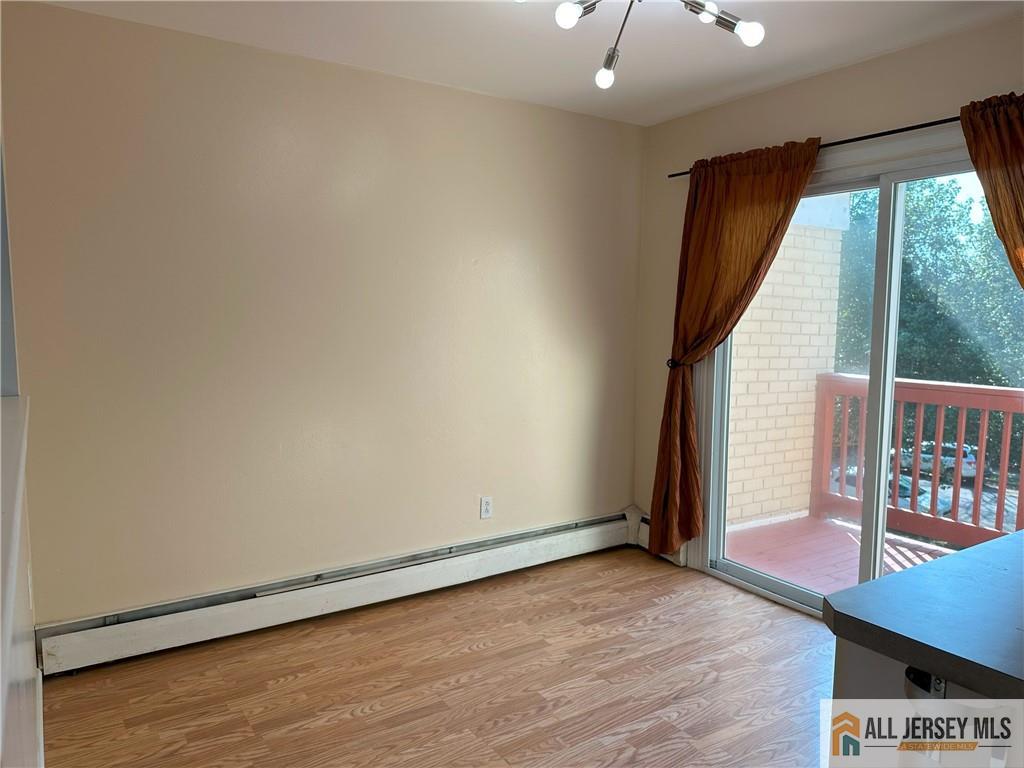 2 Lake Avenue, Unit 7B East Brunswick, NJ 08816 - Photo 7 of 10 an empty room with wooden floor and windows