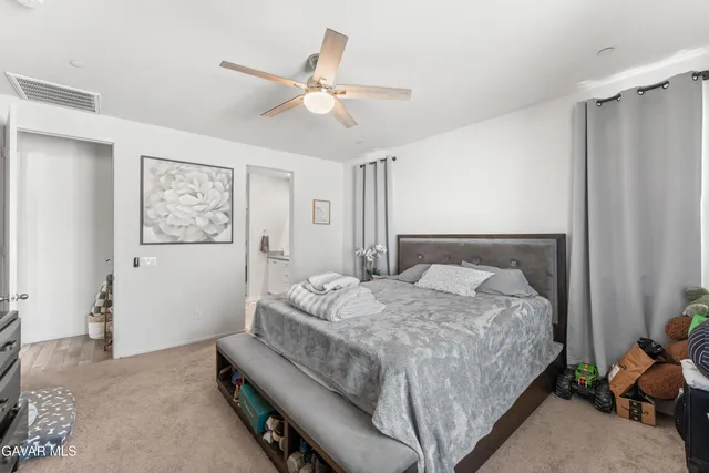 a bedroom with a bed couch and window