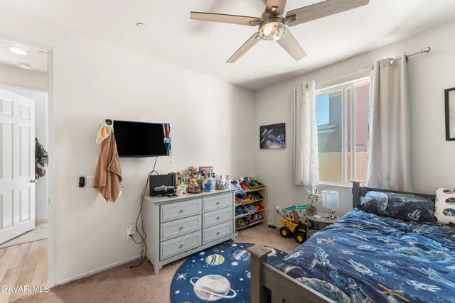a bedroom with a bed and flat screen tv