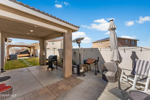 a view of a patio with table and chairs