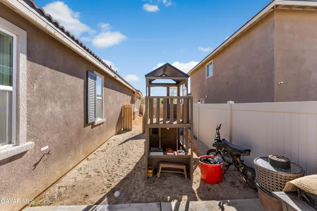 a backyard of a house with outdoor seating