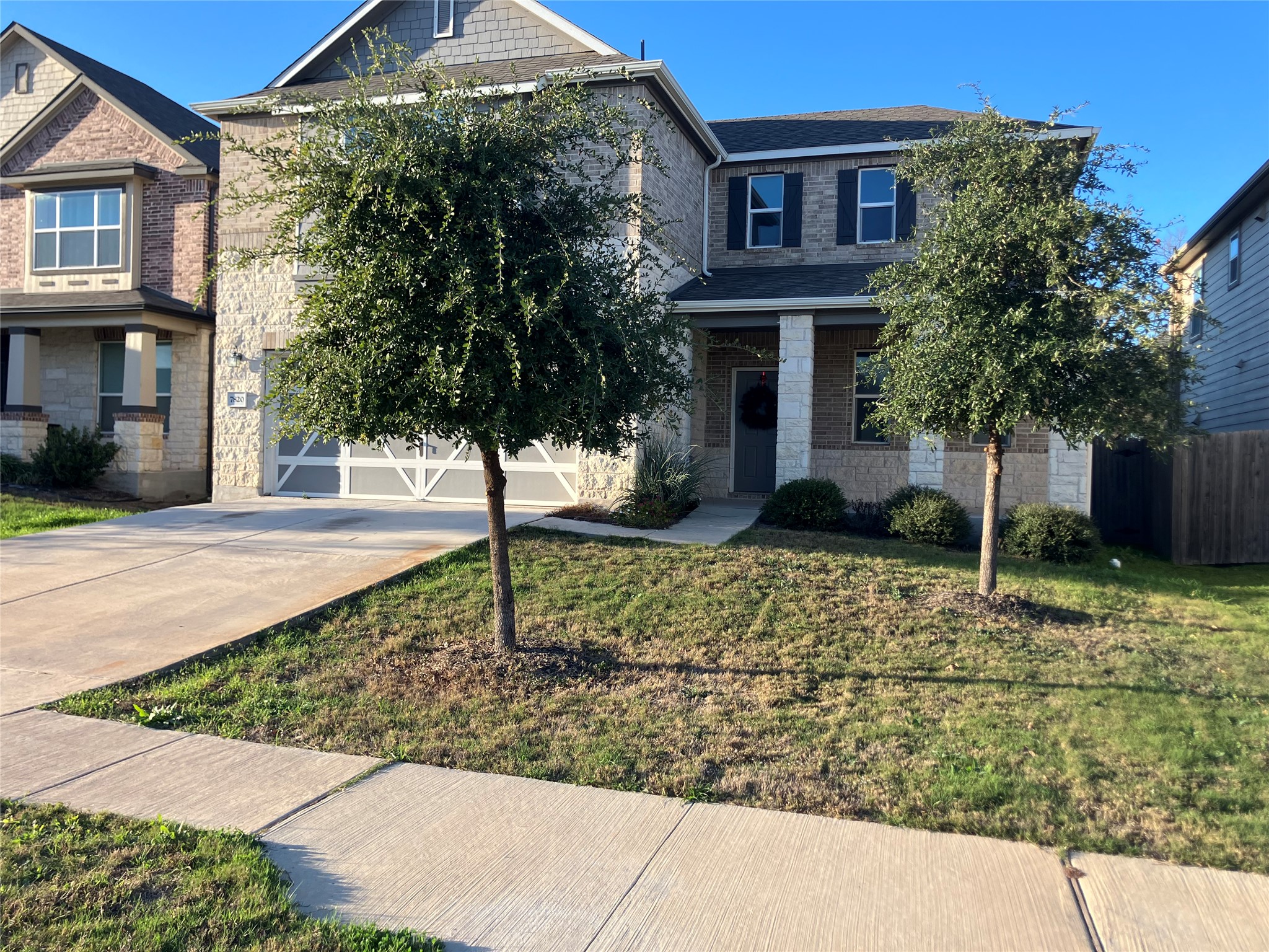 7820 Big Wind Way Austin, TX 78724 - Photo 2 of 37 a view of a brick house with a yard and large tree