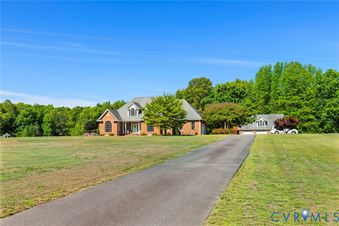 15441 Goshen Road Montpelier, VA 23192 - Photo 2 of 47 a front view of a house with a yard and garage