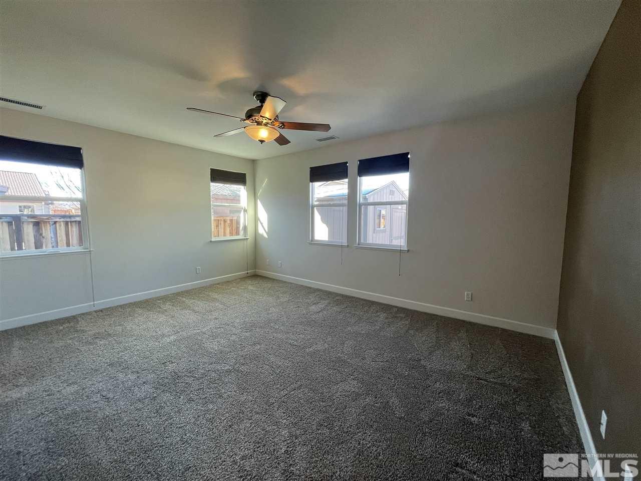 455 Terracina Way Reno, NV 89521 - Photo 13 of 36 an empty room with windows and ceiling fan