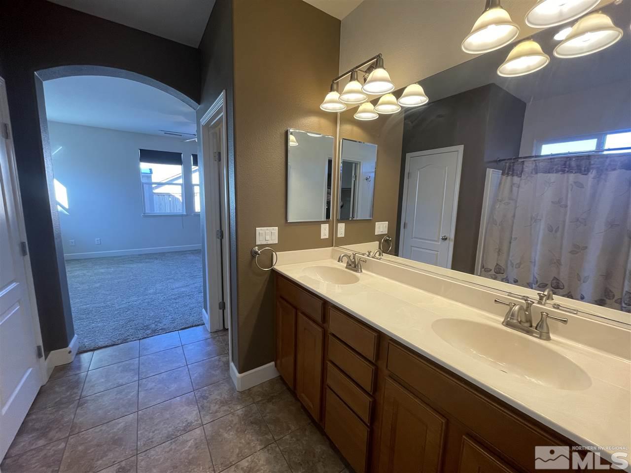 455 Terracina Way Reno, NV 89521 - Photo 16 of 36 a bathroom with a double vanity sink and a mirror