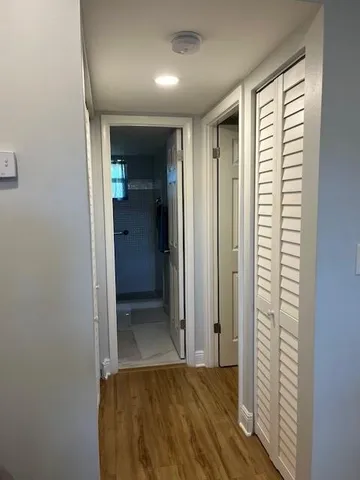 an empty room with closet and a window