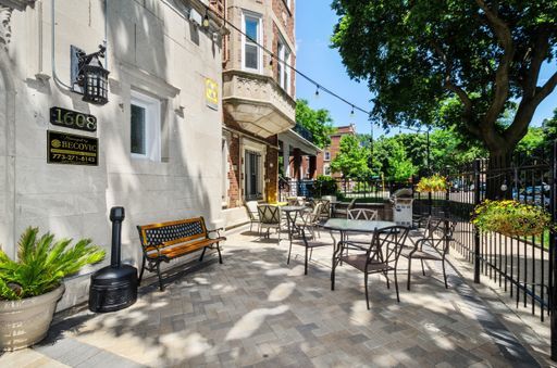 1608 West Sherwin Avenue, Unit 608 Chicago, IL 60626 - Photo 12 of 13 a view of a patio with a table and chairs and potted plants
