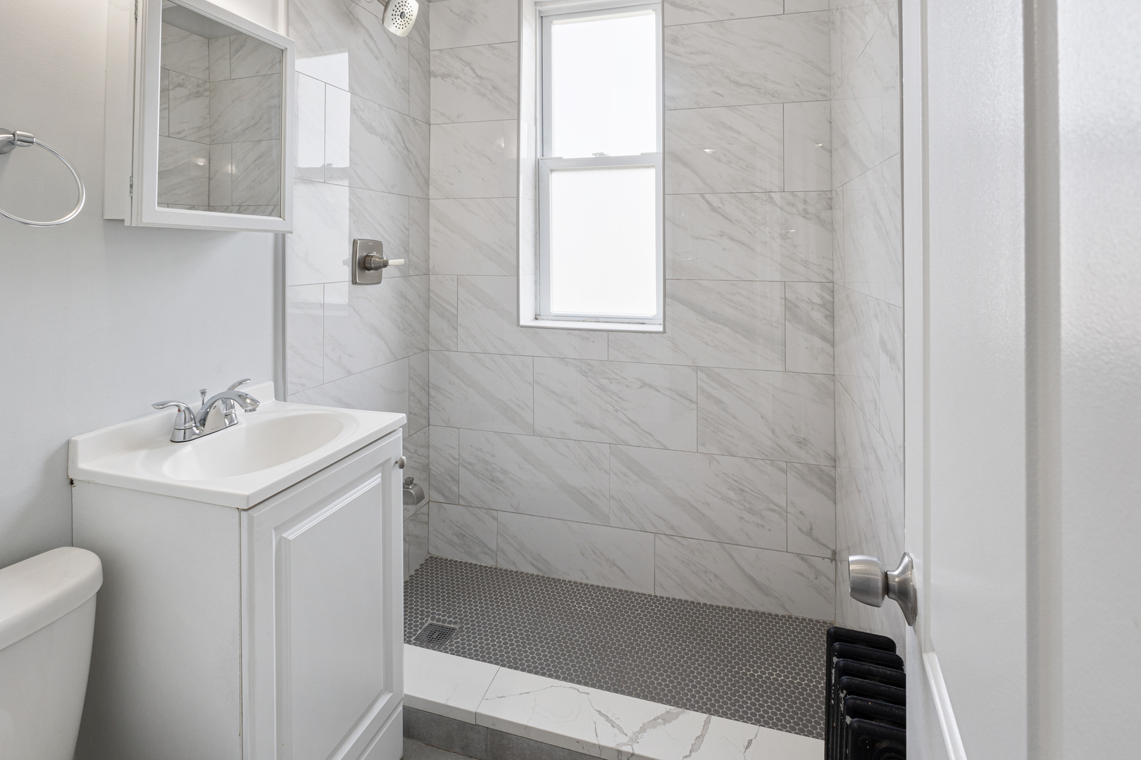 1608 West Sherwin Avenue, Unit 608 Chicago, IL 60626 - Photo 10 of 13 a bathroom with a sink a toilet and shower