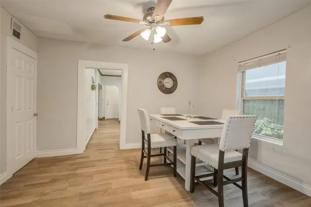 a view of a dining room with furniture and a large window