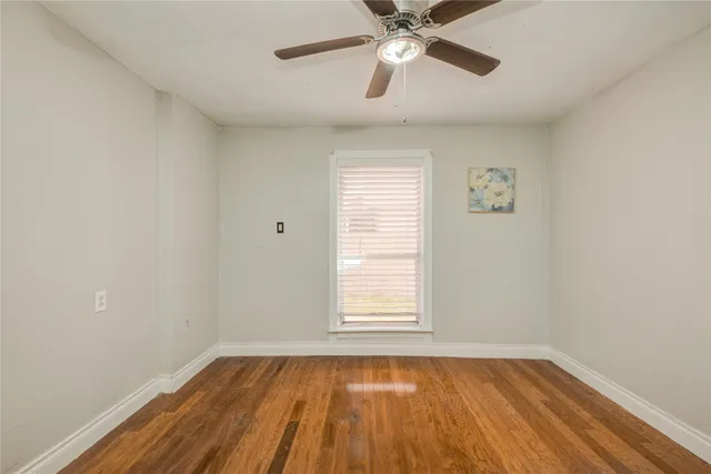wooden floor in an empty room with a window