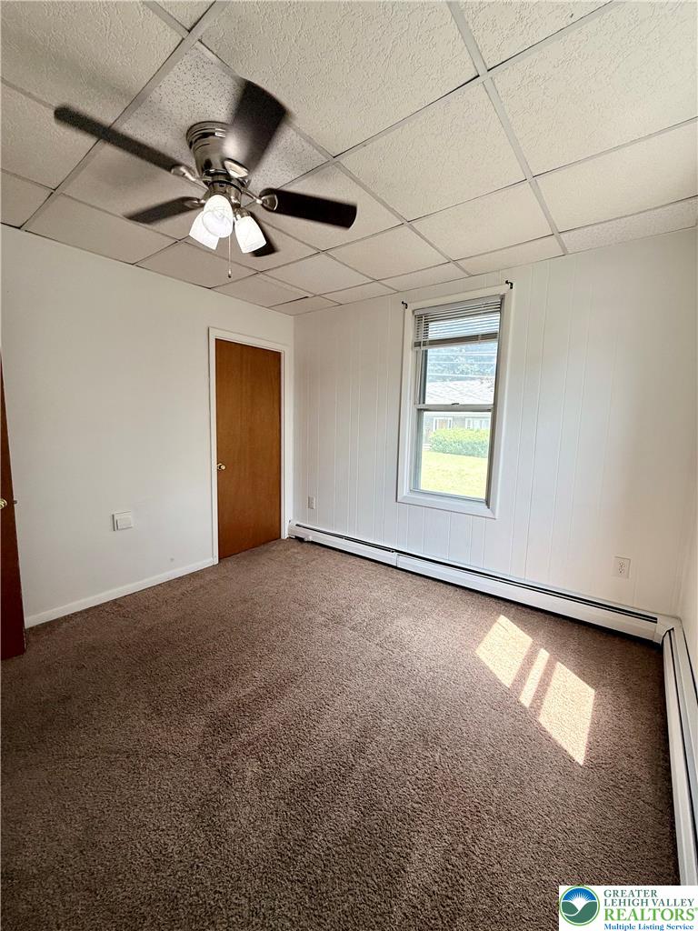 5540 Main Street Whitehall, PA 18052 - Photo 36 of 53 A well-lit bedroom features plush carpeting and a modern ceiling fan, offering a comfortable personal retreat.