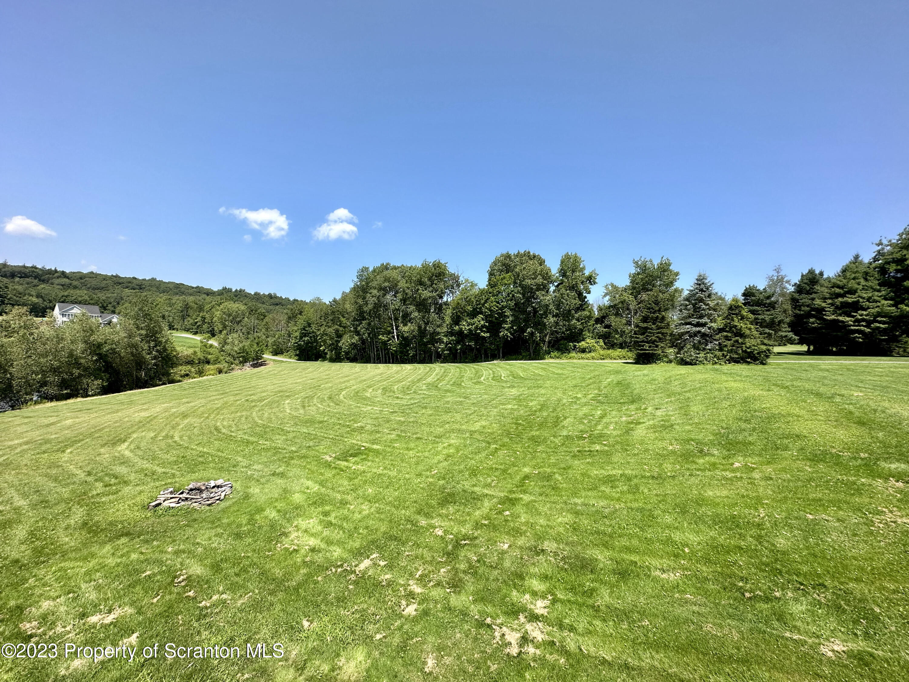 764 Coon Road Wyoming, PA 18644 - Photo 18 of 23 a view of a green field with wooden fence