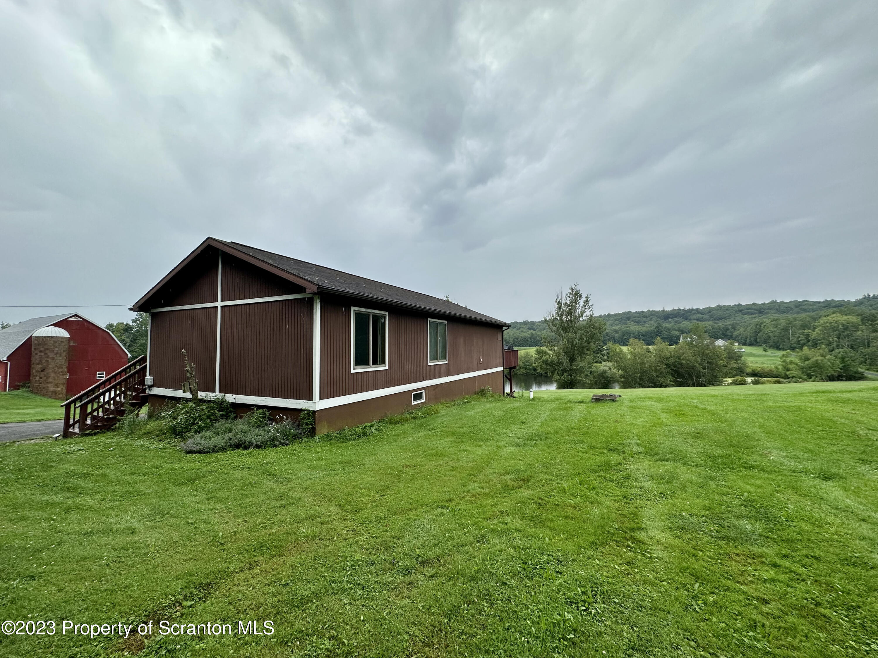 764 Coon Road Wyoming, PA 18644 - Photo 23 of 23 a backyard of a house with lots of green space